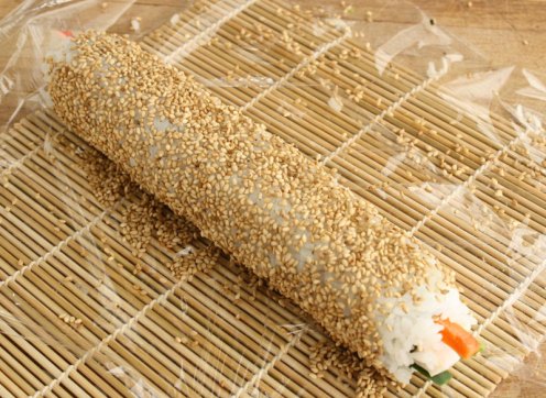 roll sushi in sesame seeds
